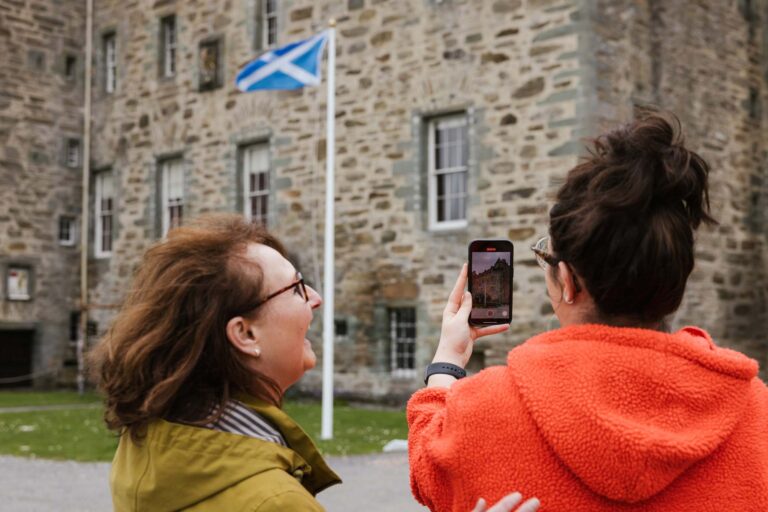 Scottish flag flying in front of a rustic building