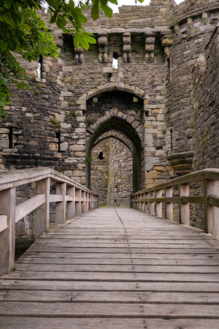 Bridge to the gatehouse and portcullis of an old stone medieval castle - Beaumaris Castle