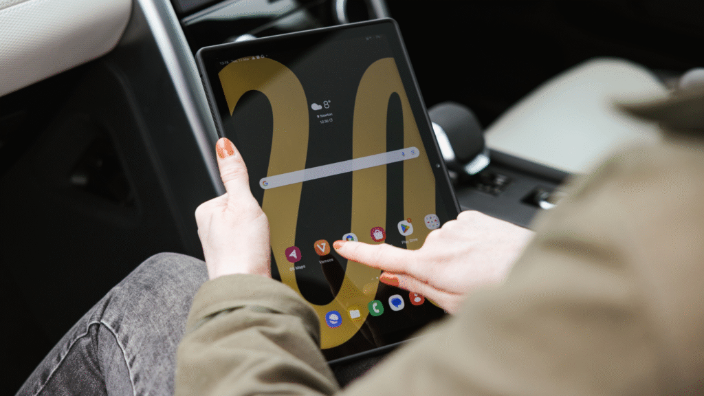 Traveller using a tablet inside a Land Rover